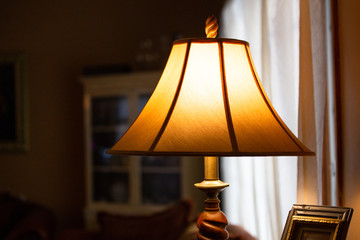 Illuminated lamp with shade in a dimly lit room