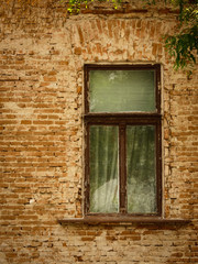Fototapeta na wymiar Old, aged, dirty wooden vintage frame window on a brick wall.
