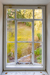 old historic window with garden view