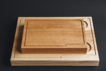 Walnut handmade wood cutting board on black wooden board
