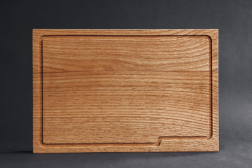 Walnut handmade wood cutting board on black wooden board