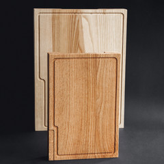 Walnut handmade wood cutting board on black wooden board
