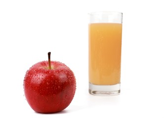 apple juice -  ​red apple with drops of water and a glass of naturally cloudy apple juice in front of white background