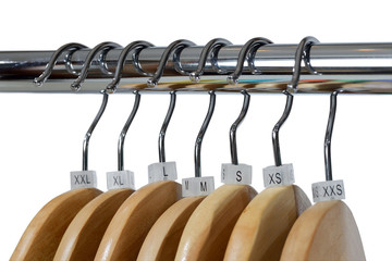 Wooden hangers with sizes tags isolated on white background.