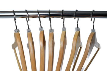 Wooden hangers with sizes tags isolated on white background.