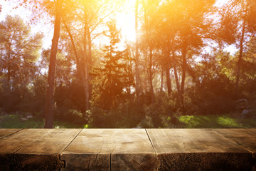 Naklejka na ściany i meble photo of front rustic wooden table and background forest