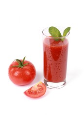 fresh tomato juice - glass with fresh tomato juice and a fresh tomato with drops of water isolated on white