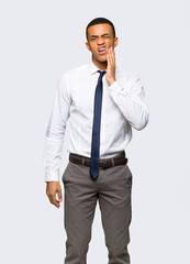 Young afro american businessman with toothache on isolated background