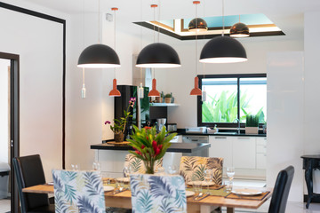 house or home building Luxury interior design in living room of pool villas. Airy and bright space with high raised ceiling and wooden dining table