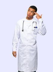 Young afro american man doctor with problems making suicide gesture on isolated background