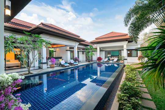 Home Or House Building  Exterior  And Interior Design Showing Tropical Pool Villa With Green Garden, With Sun Bed And Blue Sky 