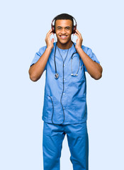 Surgeon doctor man listening to music with headphones on isolated background