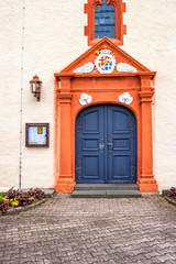 Fototapeta na wymiar Church of St. Peter and St. Paul main entrance in Buedesheim, Rhineland-Palatinate, Germany