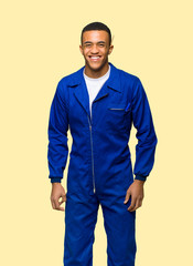 Young afro american worker man happy and smiling on isolated background