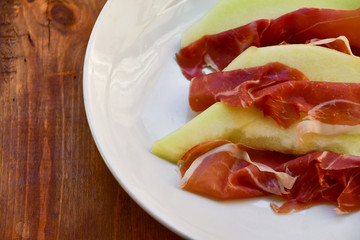  traditional Italian appetizer of prosciutto and melon. selective focus and copy space