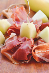  traditional Italian appetizer of prosciutto and melon. selective focus and copy space