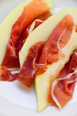 traditional Italian appetizer of prosciutto and melon. selective focus and copy space