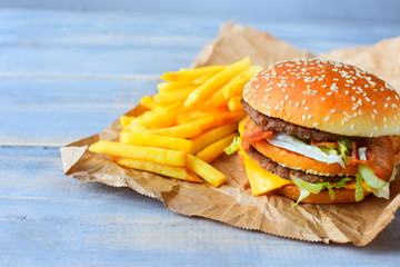 double cheeseburger with fries. takeaway lunch, fast food restaurant, fast food menu. light...
