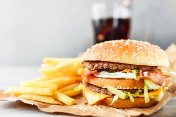 double cheeseburger with fries. takeaway lunch, fast food restaurant, fast food menu. light background, selective focus and copy space
