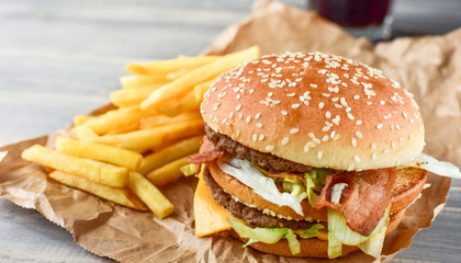 double cheeseburger with fries. takeaway lunch, fast food restaurant, fast food menu. light background, selective focus and copy space