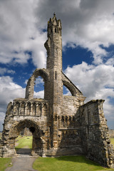Sun on stone ruins of the 14th Century West Entrance and tower of St Andrews Cathedral with clouds St Andrews Fife Scotland UK