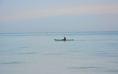 Fototapeta na wymiar lonely crossed in the sea with canoe