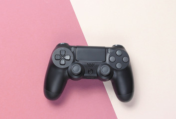 Gamepads on a colored paper background. Top view. Minimalism.