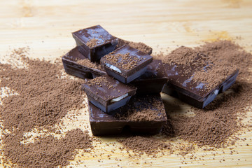 pieces of chocolate on wooden background