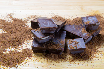 pieces of chocolate on wooden background
