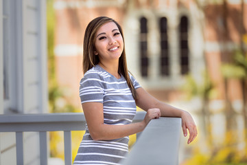 Fun cheerful smiling and laughing portrait of a beautiful asian american commercial model outdoors
