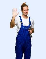 Workman saluting with hand with happy expression on isolated background
