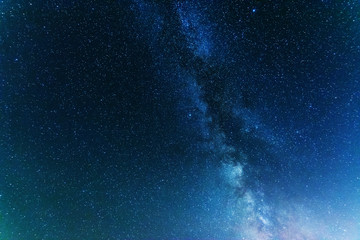 A bright starry night with millions of stars and a galaxy Milky way from the altitude of the mountain ranges.