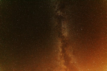 A bright starry night with millions of stars and a galaxy Milky way from the altitude of the mountain ranges.