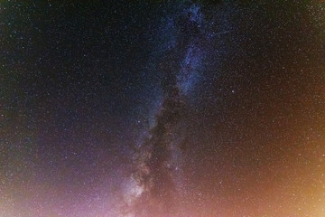 A bright starry night with millions of stars and a galaxy Milky way from the altitude of the mountain ranges.