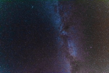 A bright starry night with millions of stars and a galaxy Milky way from the altitude of the mountain ranges.