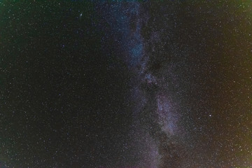 A bright starry night with millions of stars and a galaxy Milky way from the altitude of the mountain ranges.