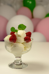 Balls of ice cream in a glass ice cream maker.