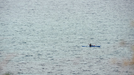 Man in row boat at open sea