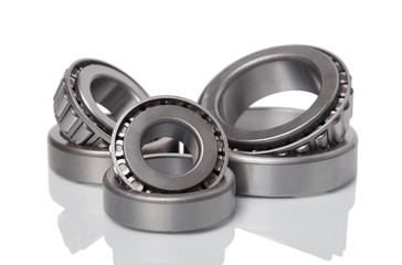 Three tapered roller bearings isoleted on white background. Small depth of focus.