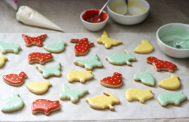 Gingerbread or shortbread cookies of various shapes, covered with colored icing. Spring or summer composition.