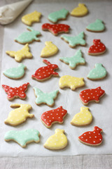 Gingerbread or shortbread cookies of various shapes, covered with colored icing. Spring or summer composition.