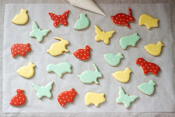 Gingerbread or shortbread cookies of various shapes, covered with colored icing. Spring or summer composition.