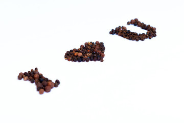 From the peppercorns to the white background, the forming words - I love you. Selective focus.