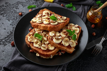 French cinnamon toast with banana, nuts and hazelnut, honey.