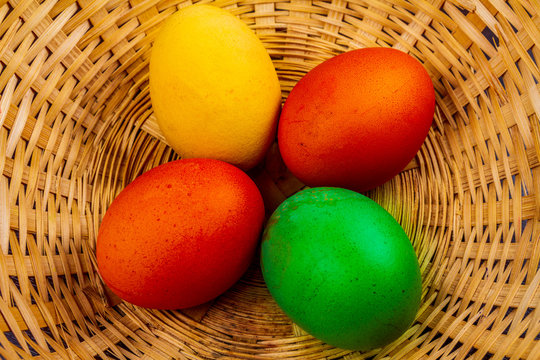 Four colorful easter eggs in basket isolated 