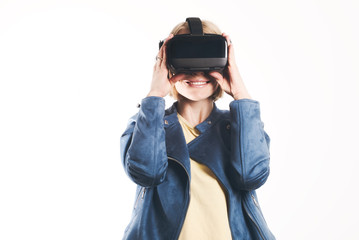 A young woman is wearing virtual reality glasses and reaching for something with his hands