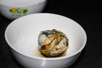 Fetal Duck Egg Balut in a white bowl, Vietnamese cuisine 