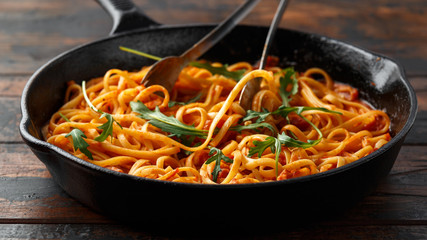 Spaghetti alla Amatriciana with pancetta bacon, tomatoes and pecorino cheese. served in cast iron skillet.