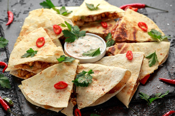 Mexican quesadilla with chicken, cheese and peppers, yogurt dip and chilli.