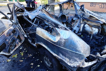 Burnt car on a city street